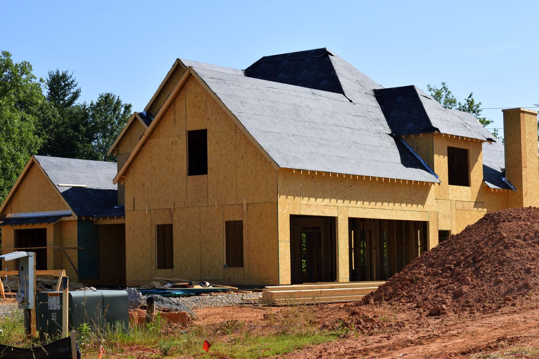 New two-story home under construction with exterior wall sheathing before insulation